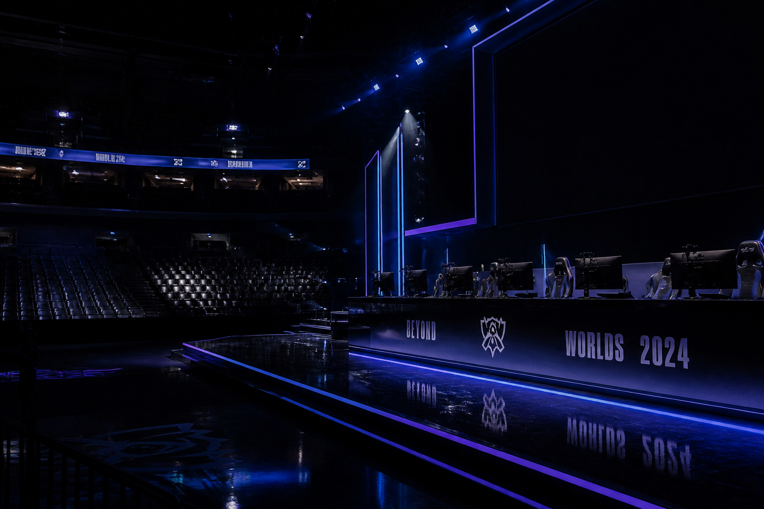 An empty esports arena stage with dark screens and vacant player chairs, signifying a postponed tournament.